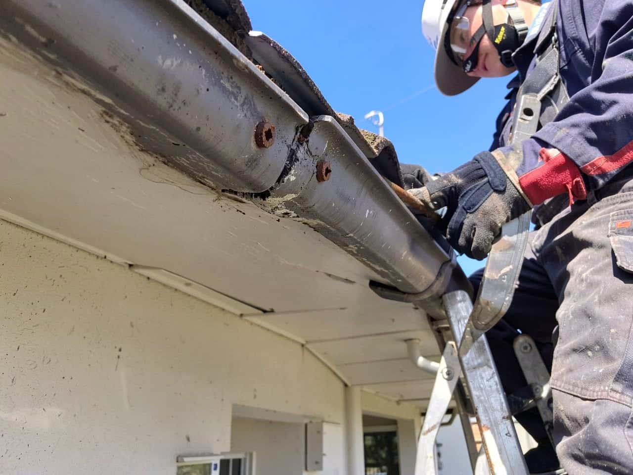 Residential gutter repair detail with restored alignment and fastening