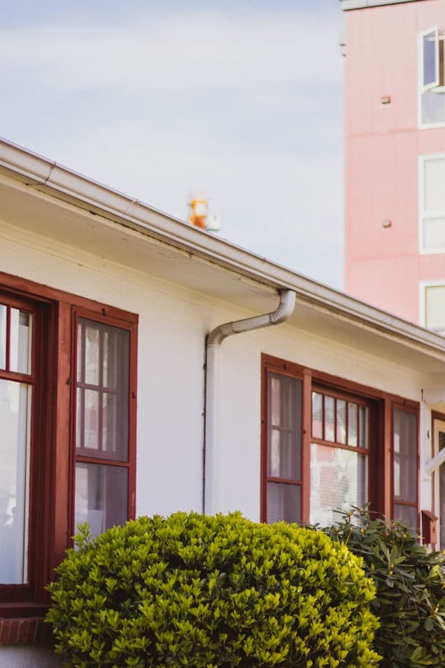 Bright suburban home exterior with visible gutter system and clean roofline.